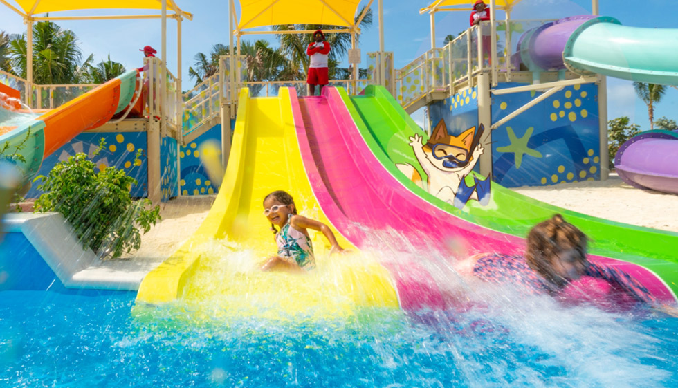 Kids and KeeKee enjoying water slides during cruise