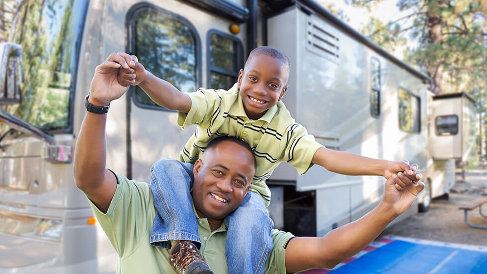 Father & son in front of RV Camper