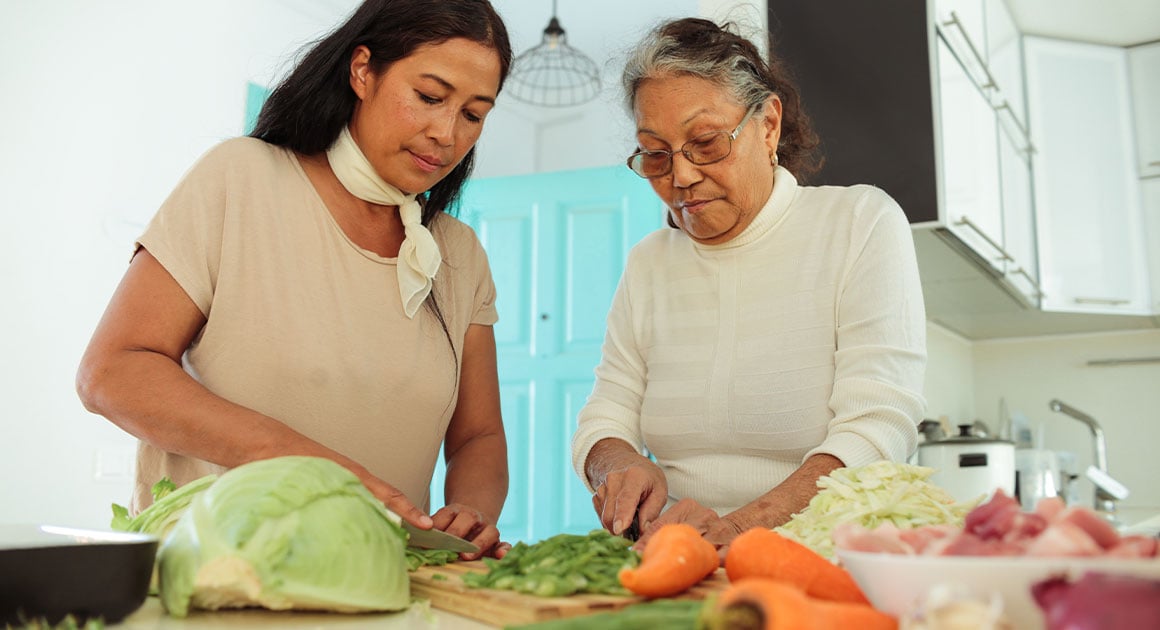 mother and daughter cooking a meal