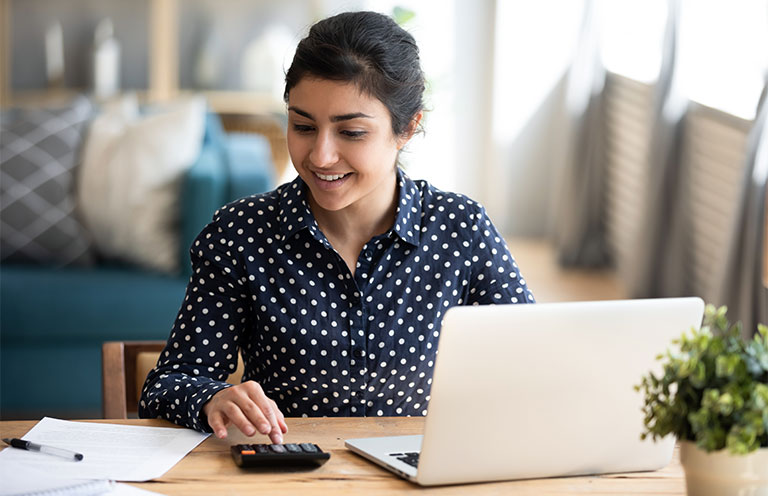 woman using laptop and calculator
