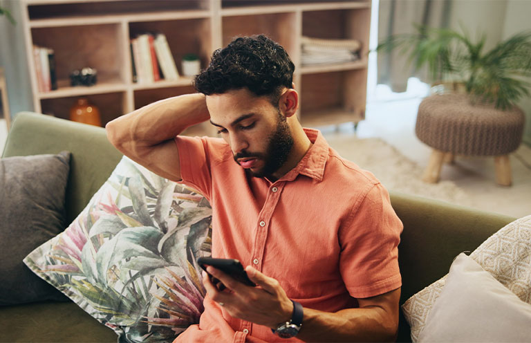 man looking at phone in a concerned manner