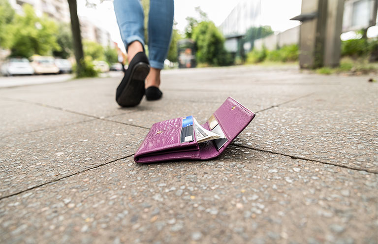 wallet on ground, woman walking away from it