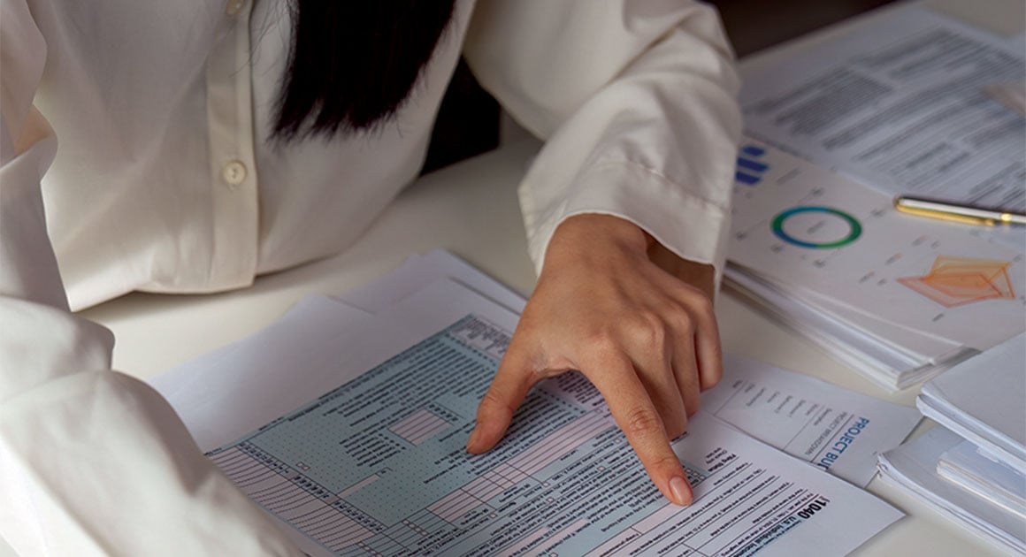 woman looking at tax form
