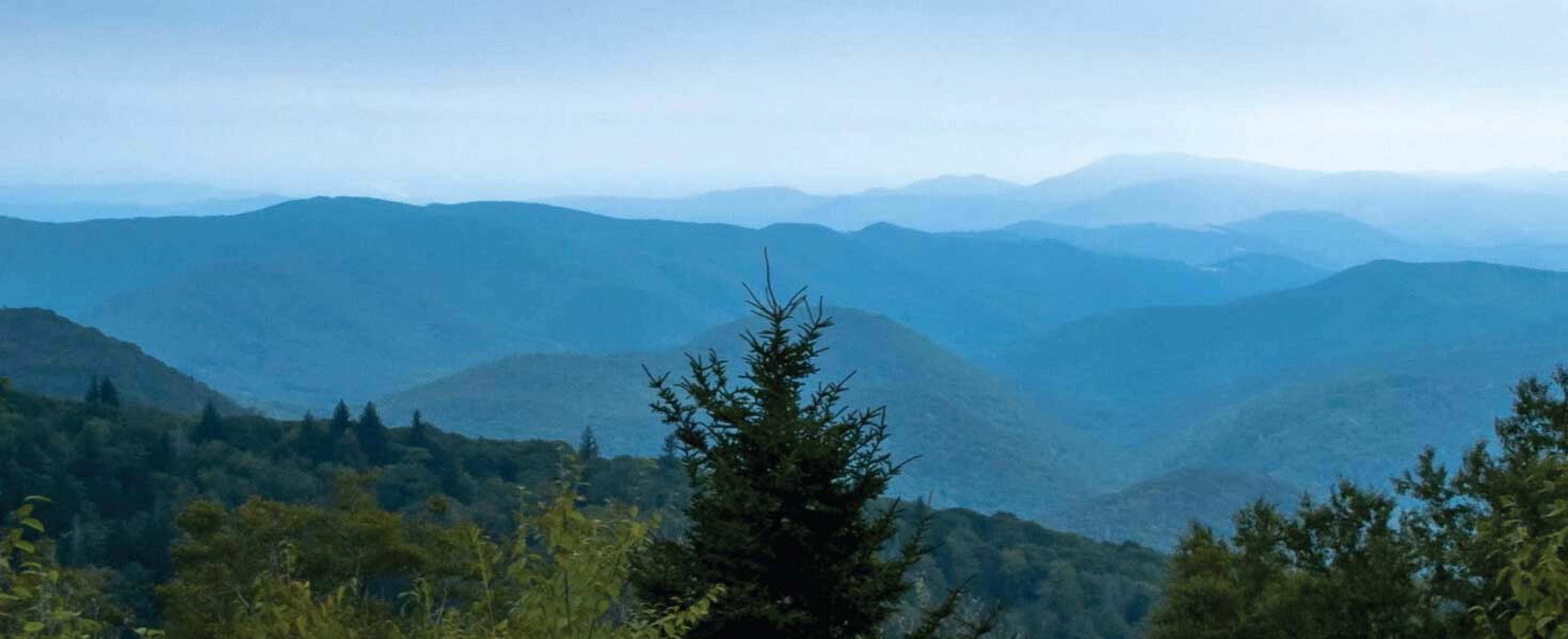 Early morning overlook of blue tinted mountains.
