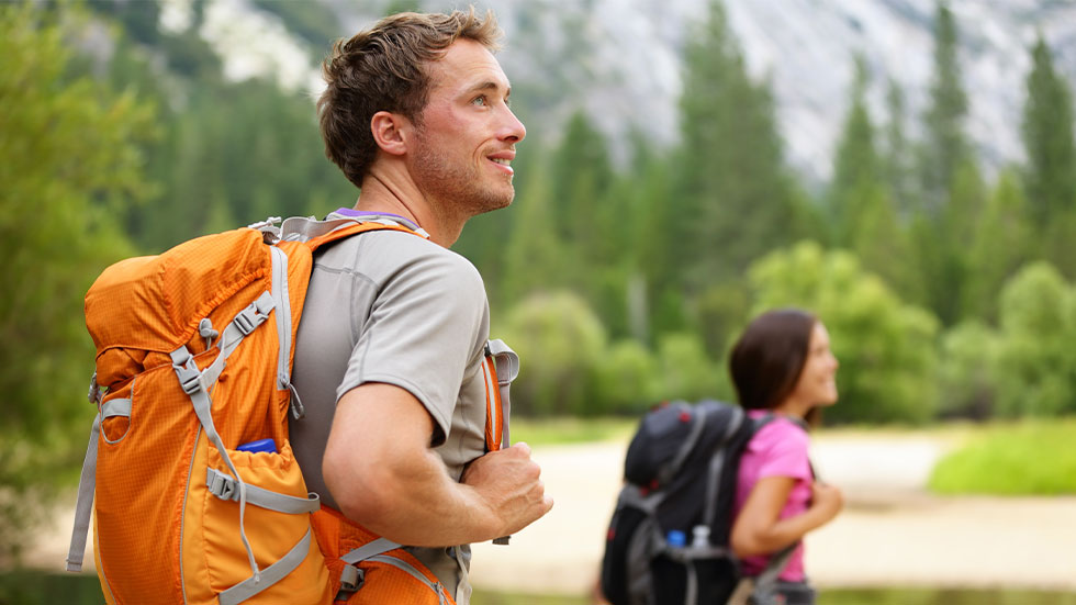 Man and woman hiking with backpacks
