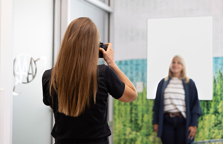 woman taking photo of another woman at an AAA office