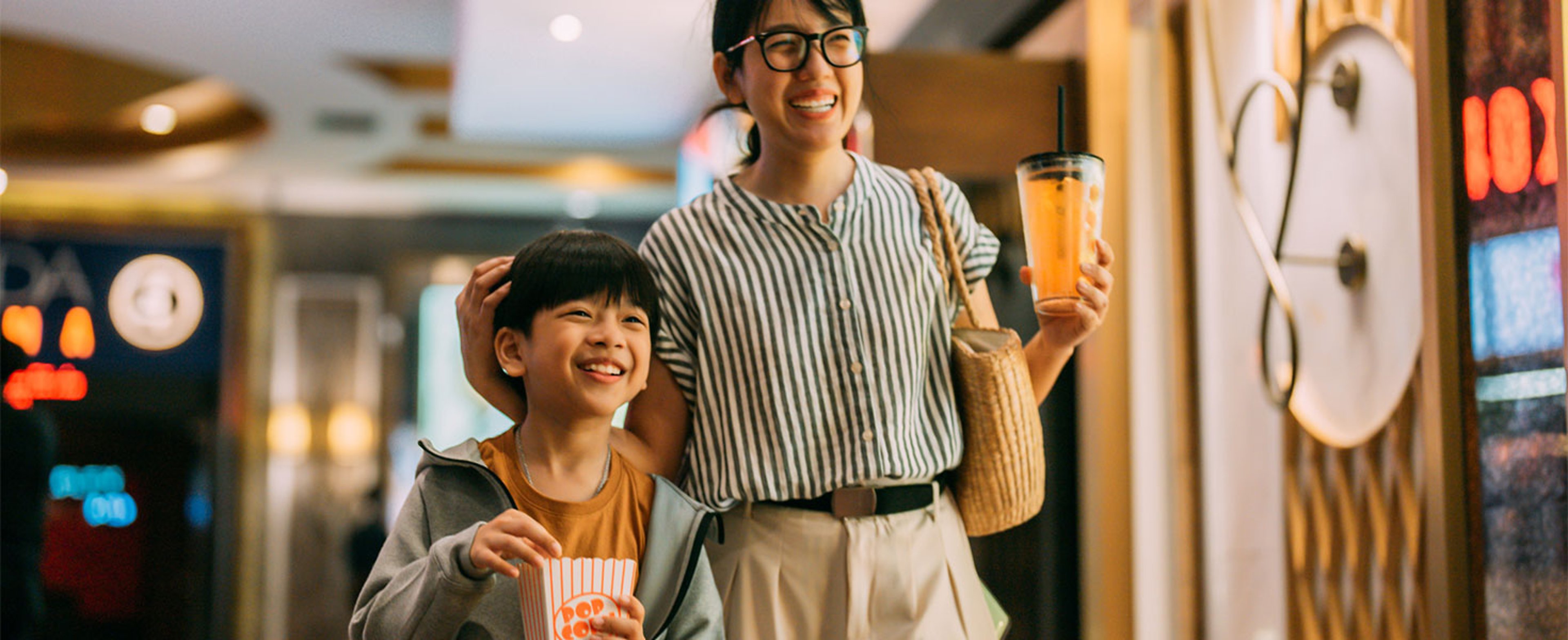mother and son with refreshments at movie theater