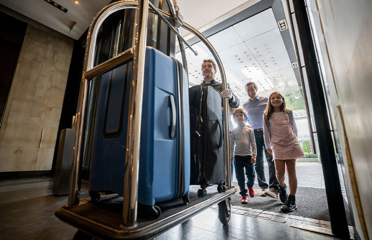 family entering hotel with bell hop