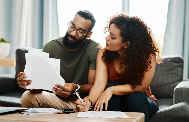 man and woman looking over documents