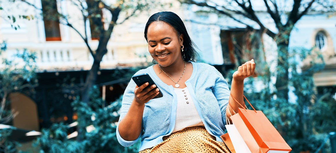 woman smiling and using smart phone