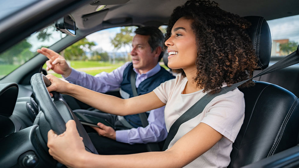 teenage girl in car with driving school instructor