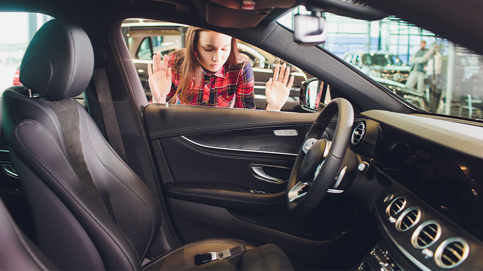 girl looking at keys locked in car