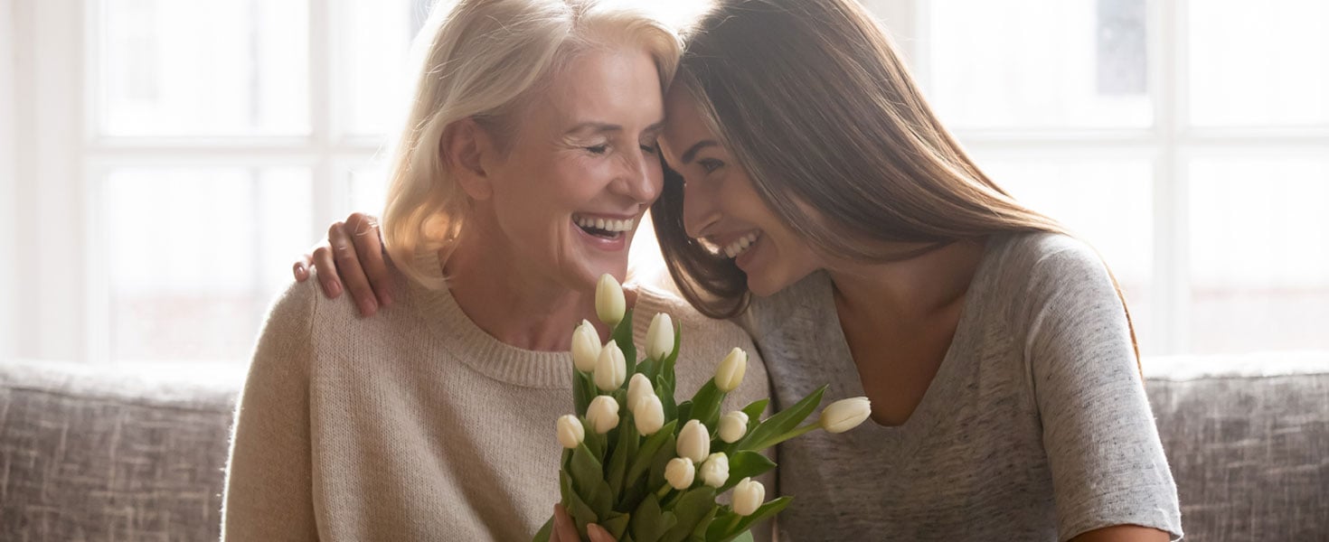 Two woman celebrating with flowers