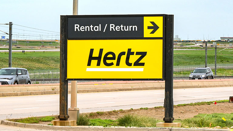 Denver, Colorado, USA - 4 June 2025: Sign for car rental returns at the entrance to the rental car depot for Hertz at Denver International Airport.  by Cerib