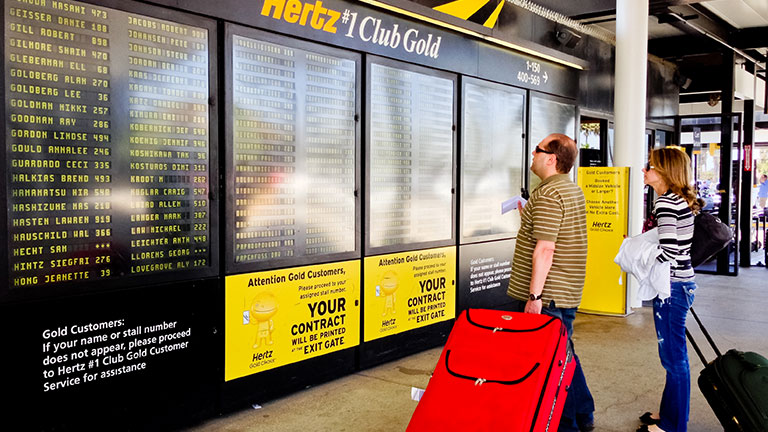 Hertz Customers looking at their names on schedule; Credit: anouchka