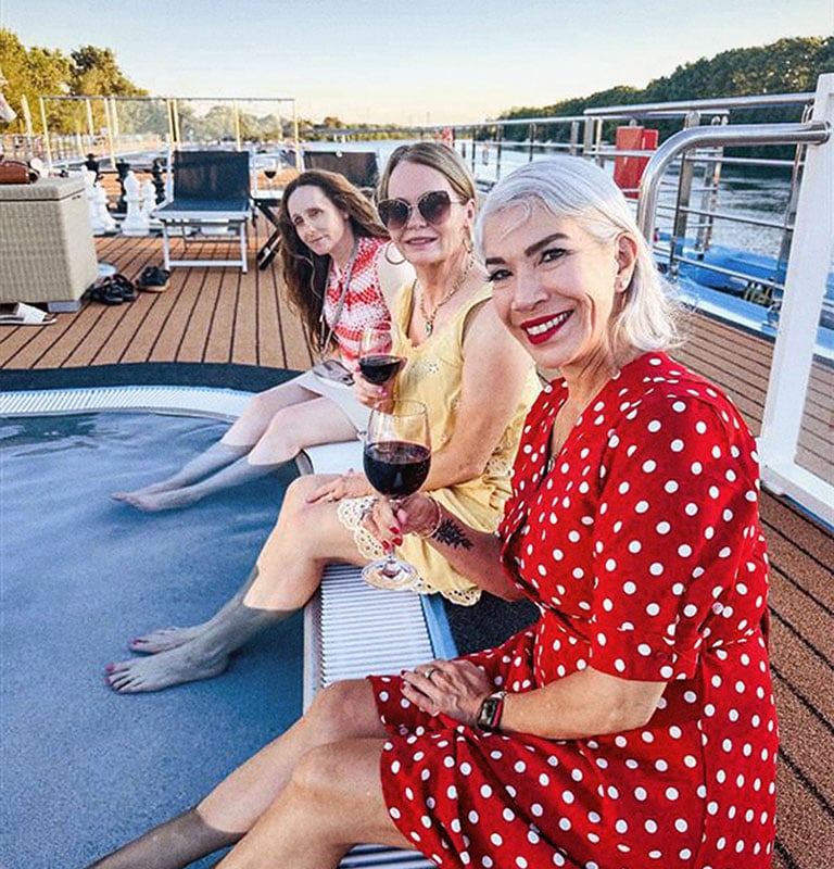 friends holding wine glasses on amawaterways ship