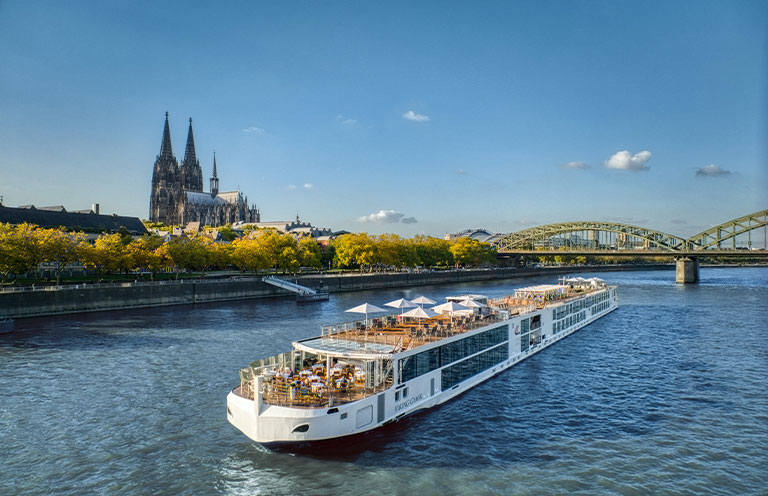 river cruise ship in front of cologne cathedral
