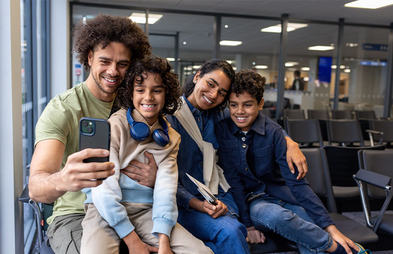 family taking selfie at airport