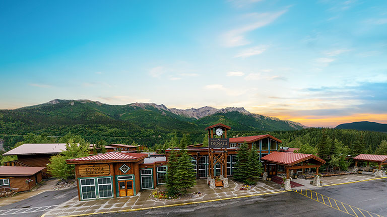 Aerial view of McKinley Chalet Resort surrounded by dense forest near Denali National Park.