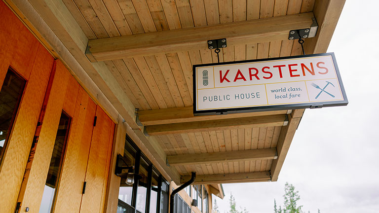 Karstens Public House with outdoor seating and surrounding trees at McKinley Chalet Resort.