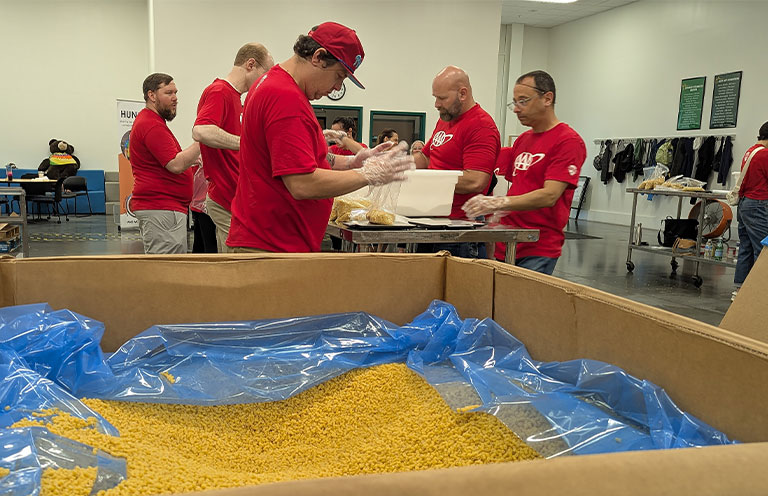 AAA workers packing food at food bank