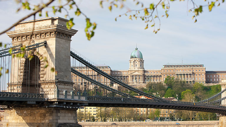Széchenyi Chain Bridge spanning the Danube River with Buda Castle on the hillside behind it.