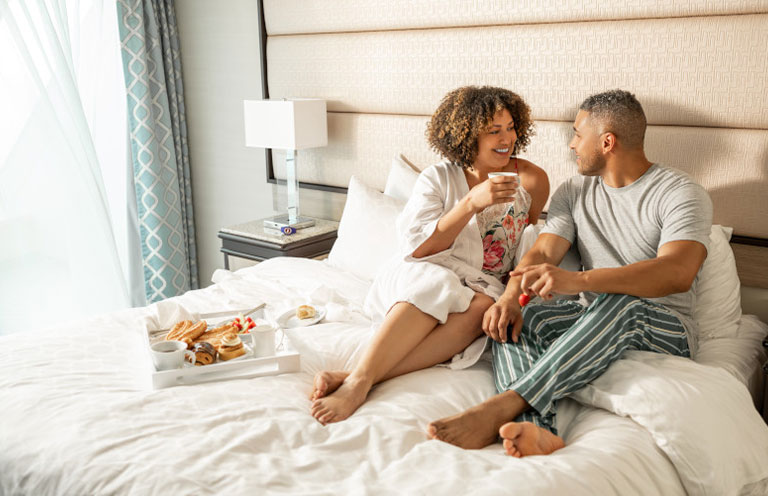 man and woman having breakfast in bed on Princess Cruises