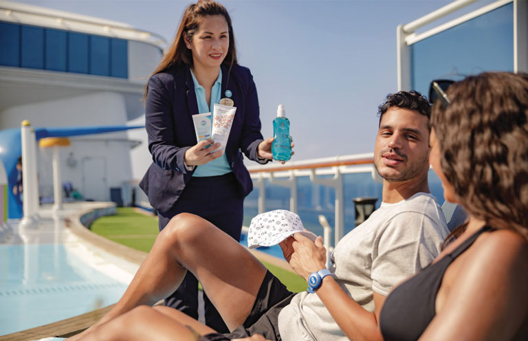 Princess Cruises staff offering products to customers while they sit near pool