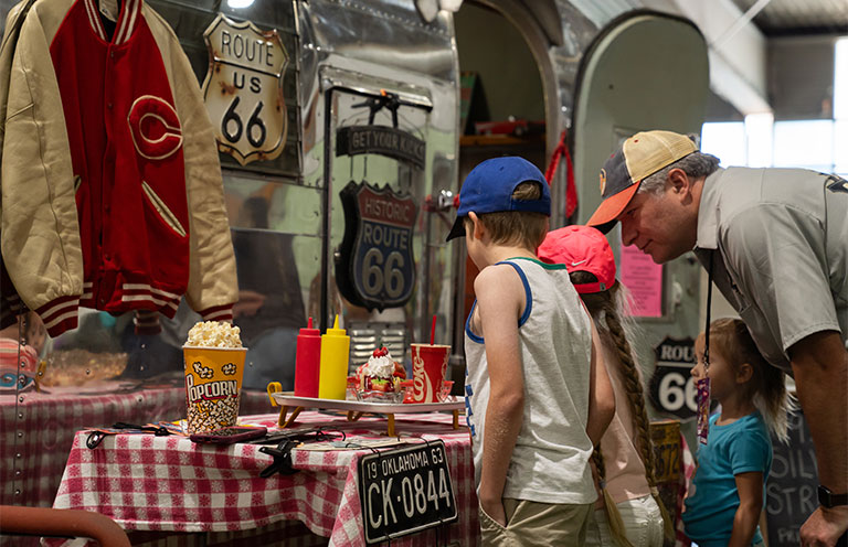 family looking at rt 66 artifacts