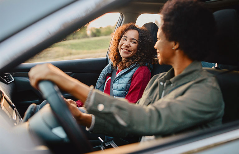older and younger women in car