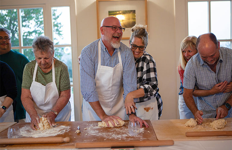 people rolling dough in cooking class