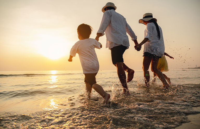 family running on beach