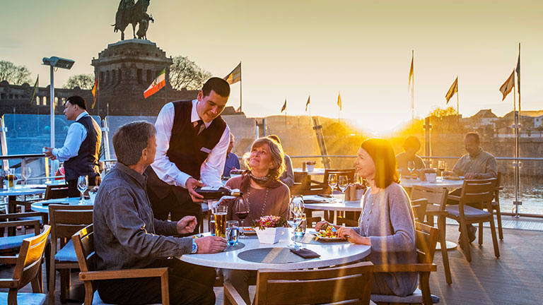 Guests enjoy cocktails aboard Aquavit Terrace at sunset; photo courtesy of Viking