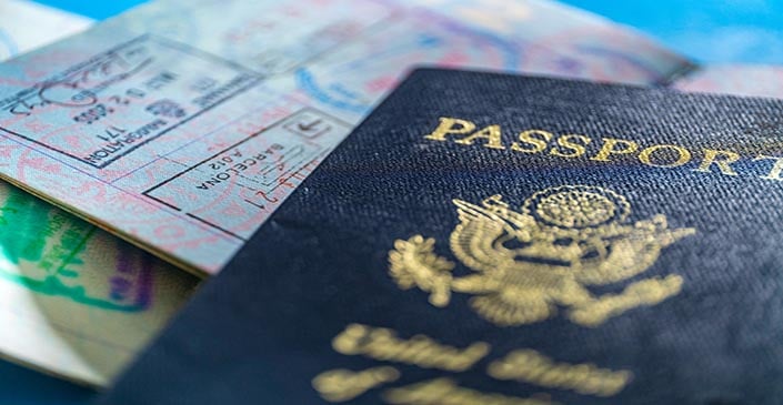 Close-up of a U.S. passport and visa pages with stamps.