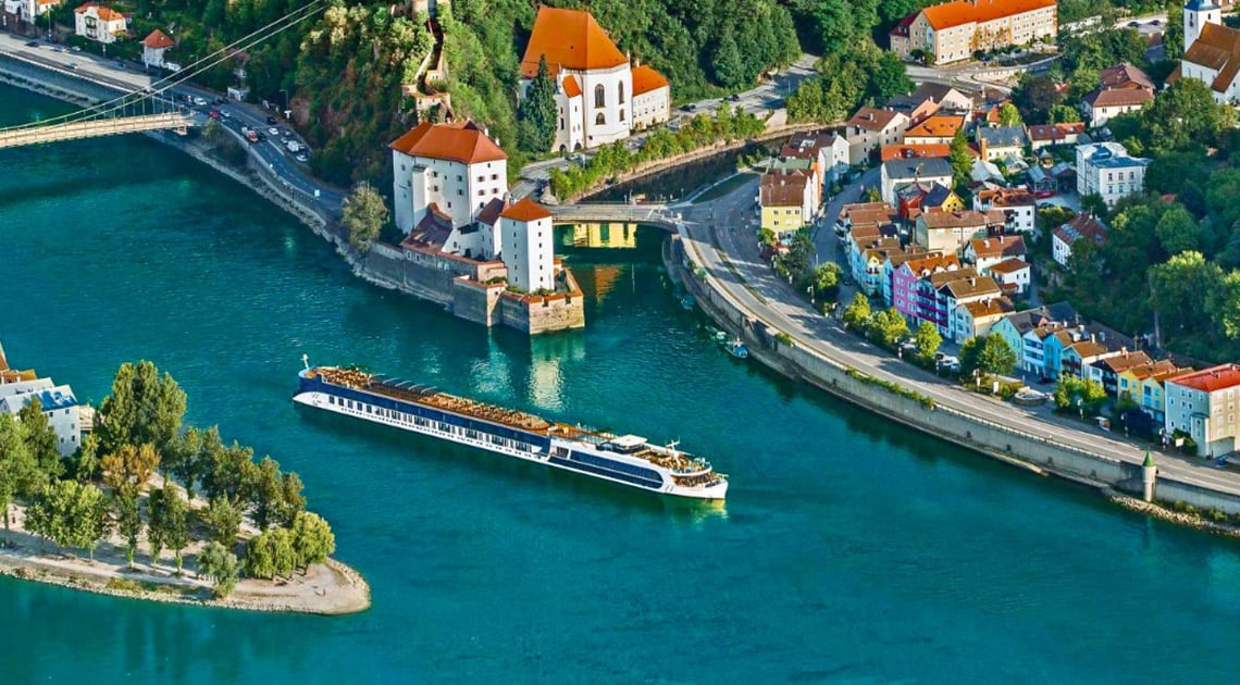 river cruise ship sailing along European village