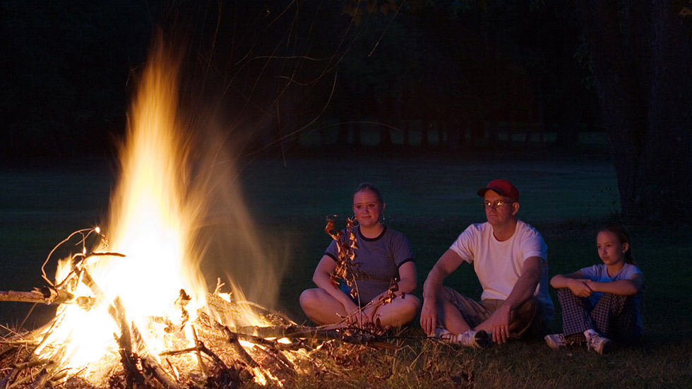 family around campfire