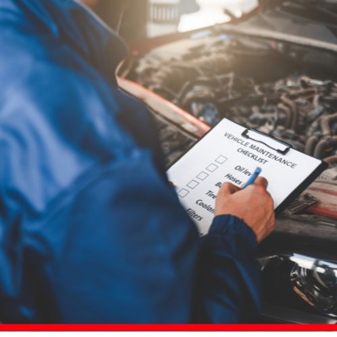 Person holding a vehicle maintenance checklist near an open car hood.