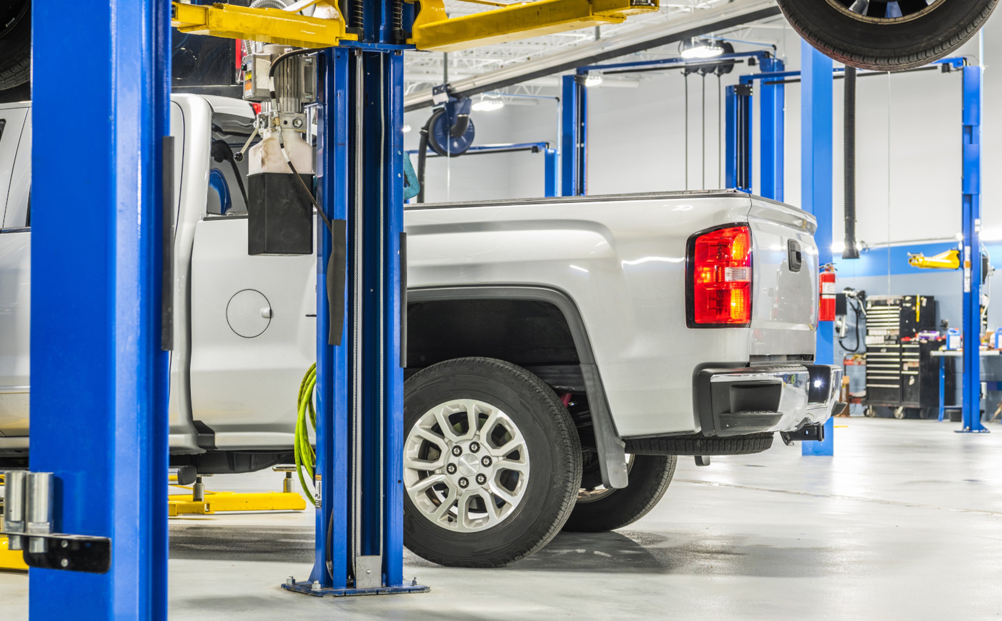 Silver pickup truck in auto repair car care shop