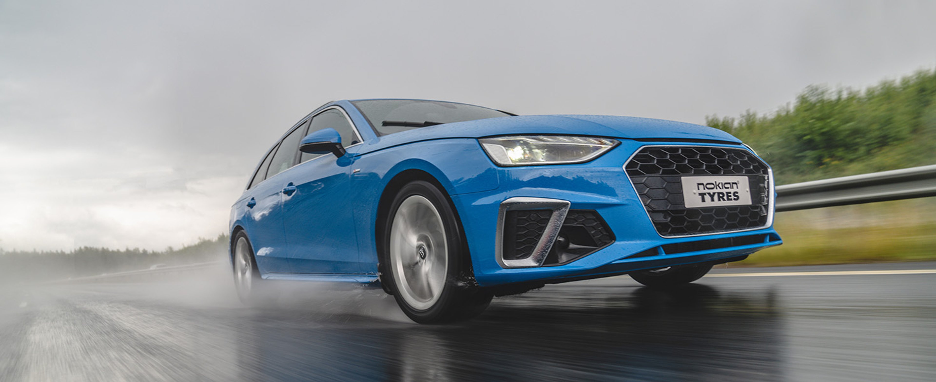 Blue car on highway with Nokian Tyres front license plate