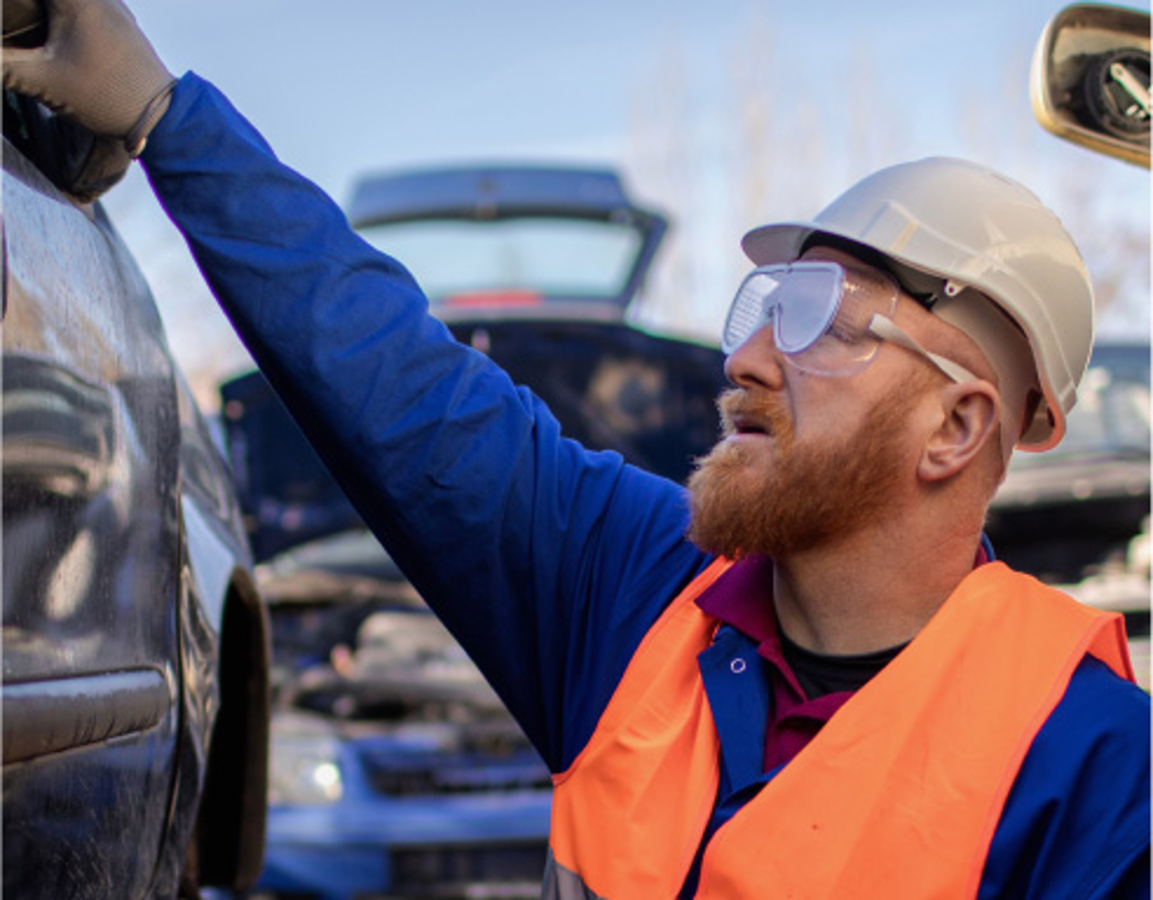 AAA roadside technician working on a car outside