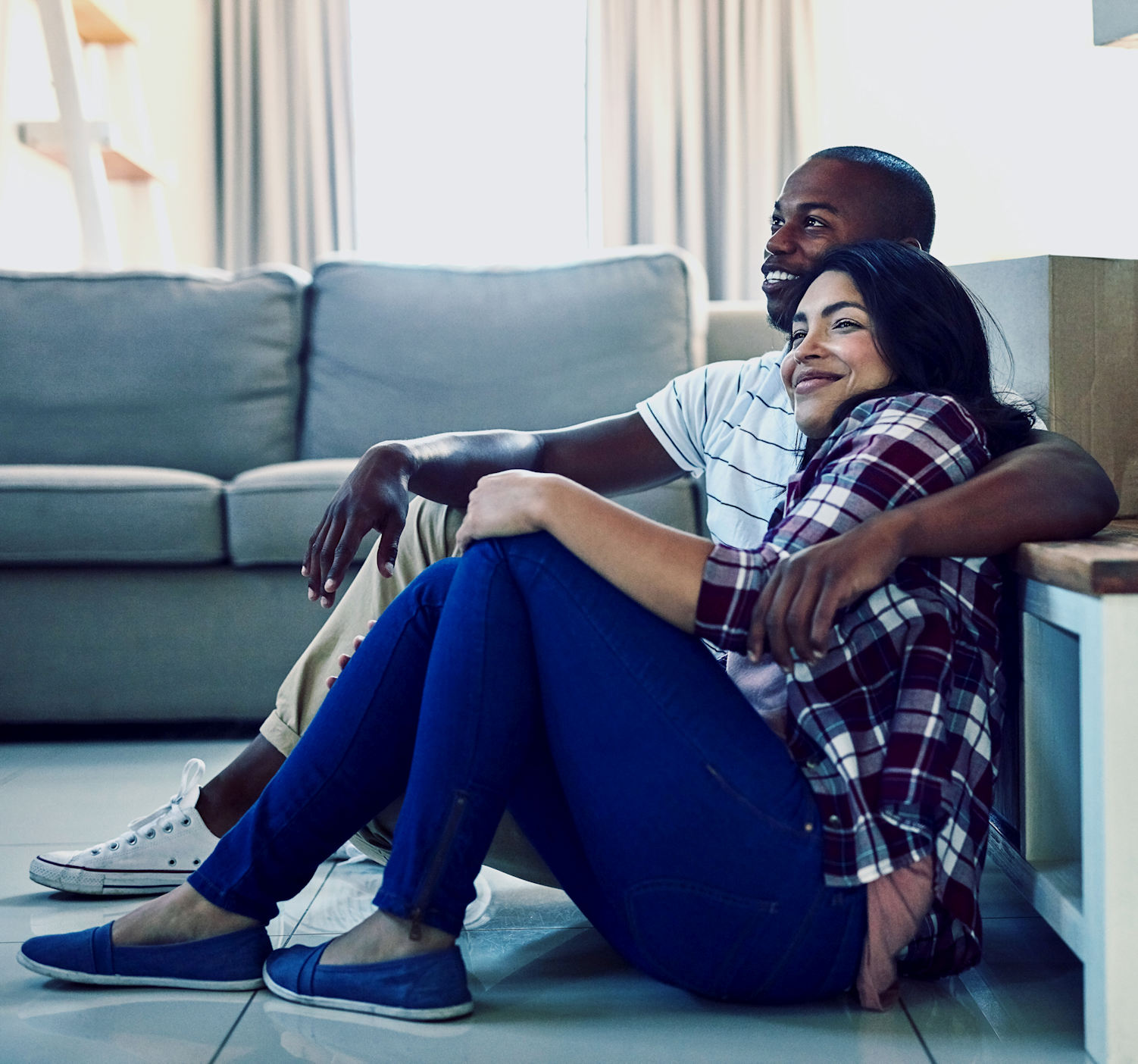 happy couple in an embrace watching tv