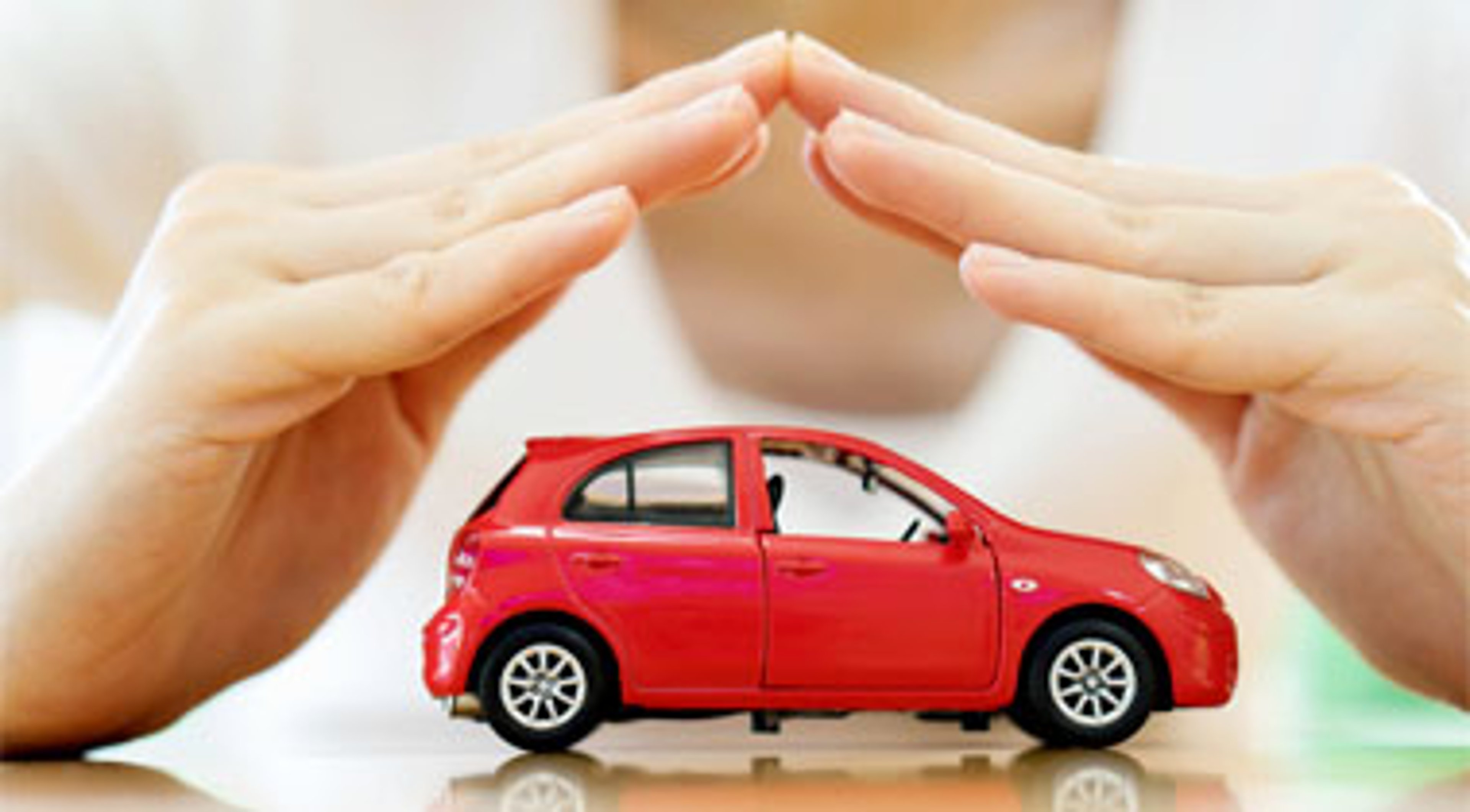 Female hands shows protection over car