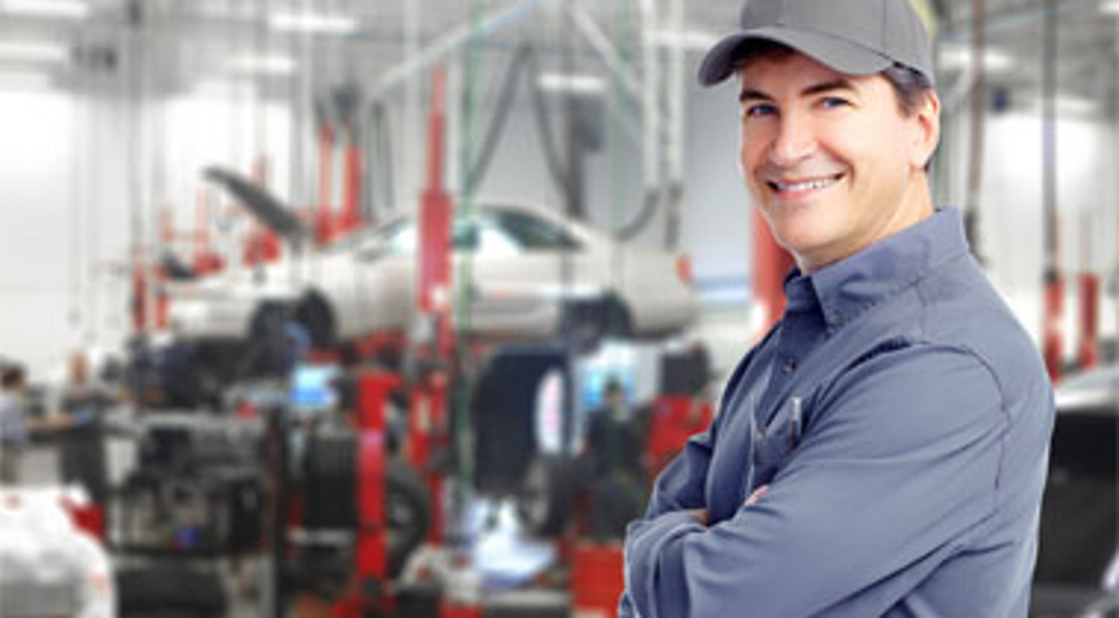 Auto repair mechanic smiling at the auto shop