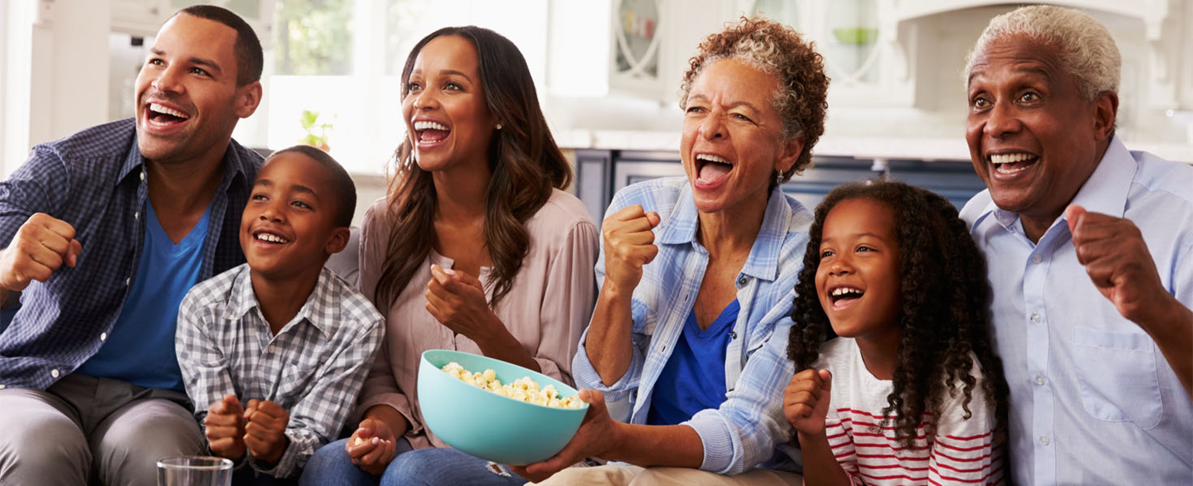 Large family watching TV at home