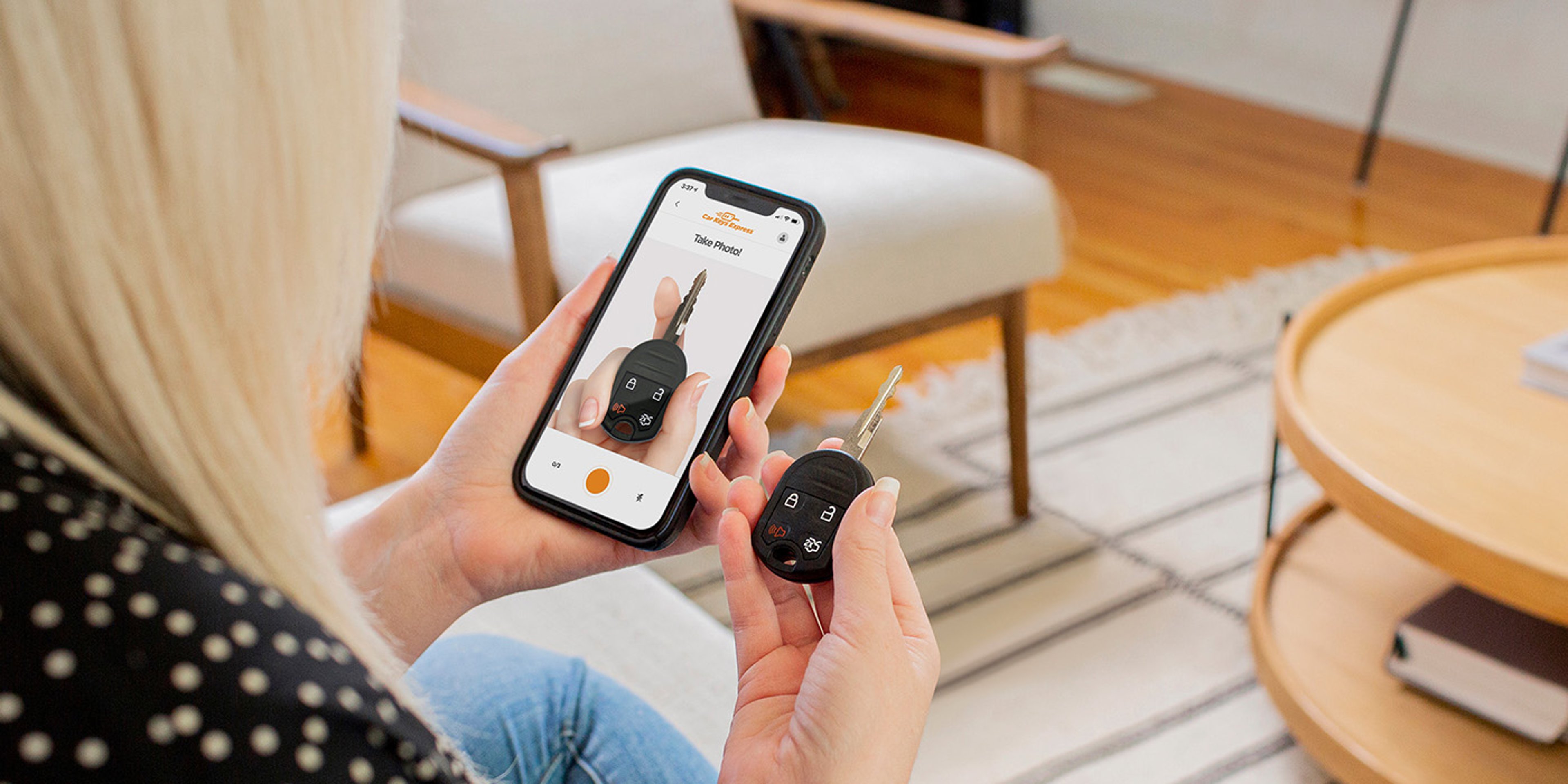 Woman browsing Car Keys Express options on mobile phone while holding car key