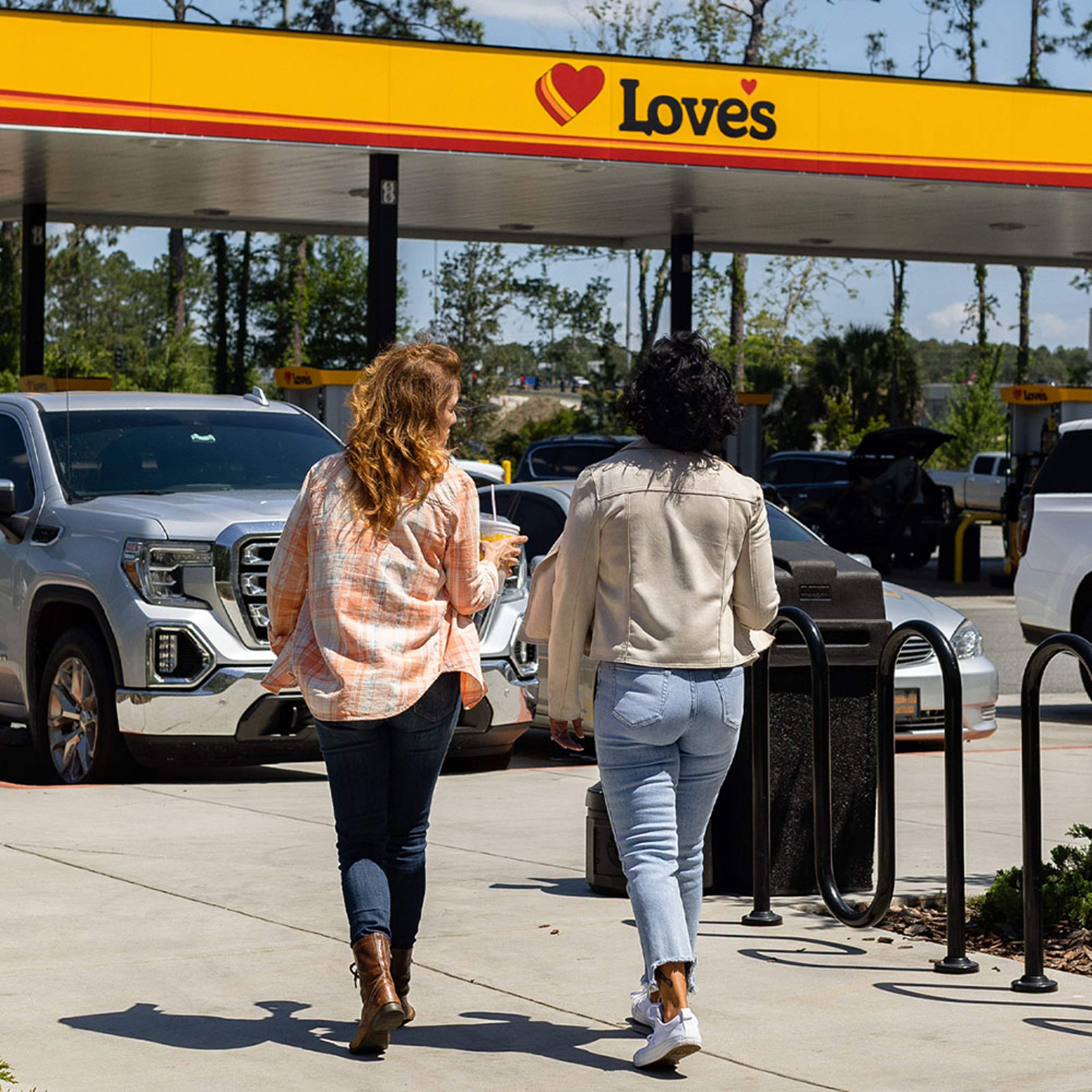 Women friends on roadtrip fueling up at Love's gas station