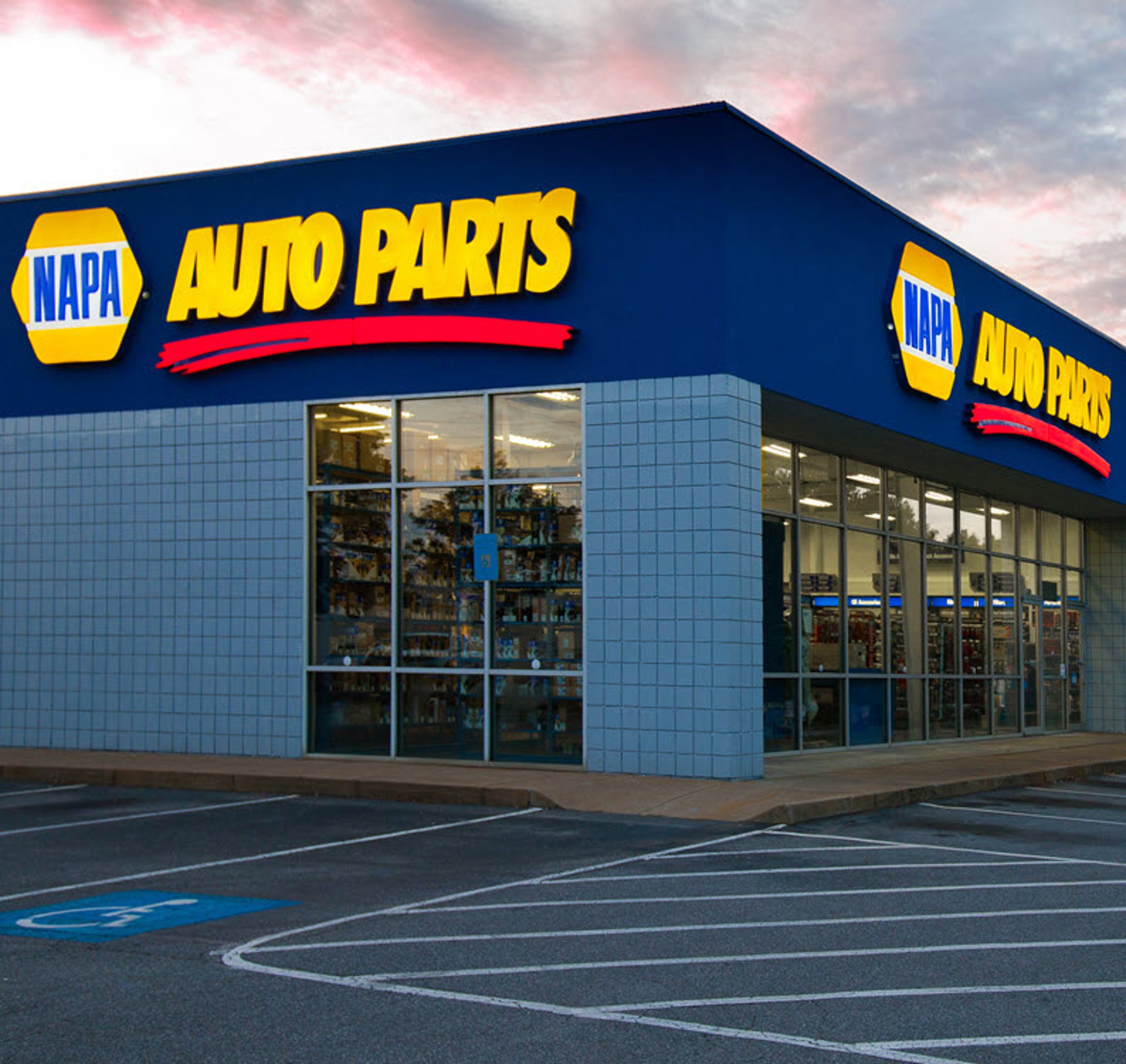 Exterior of NAPA Auto Parts store location at sunset