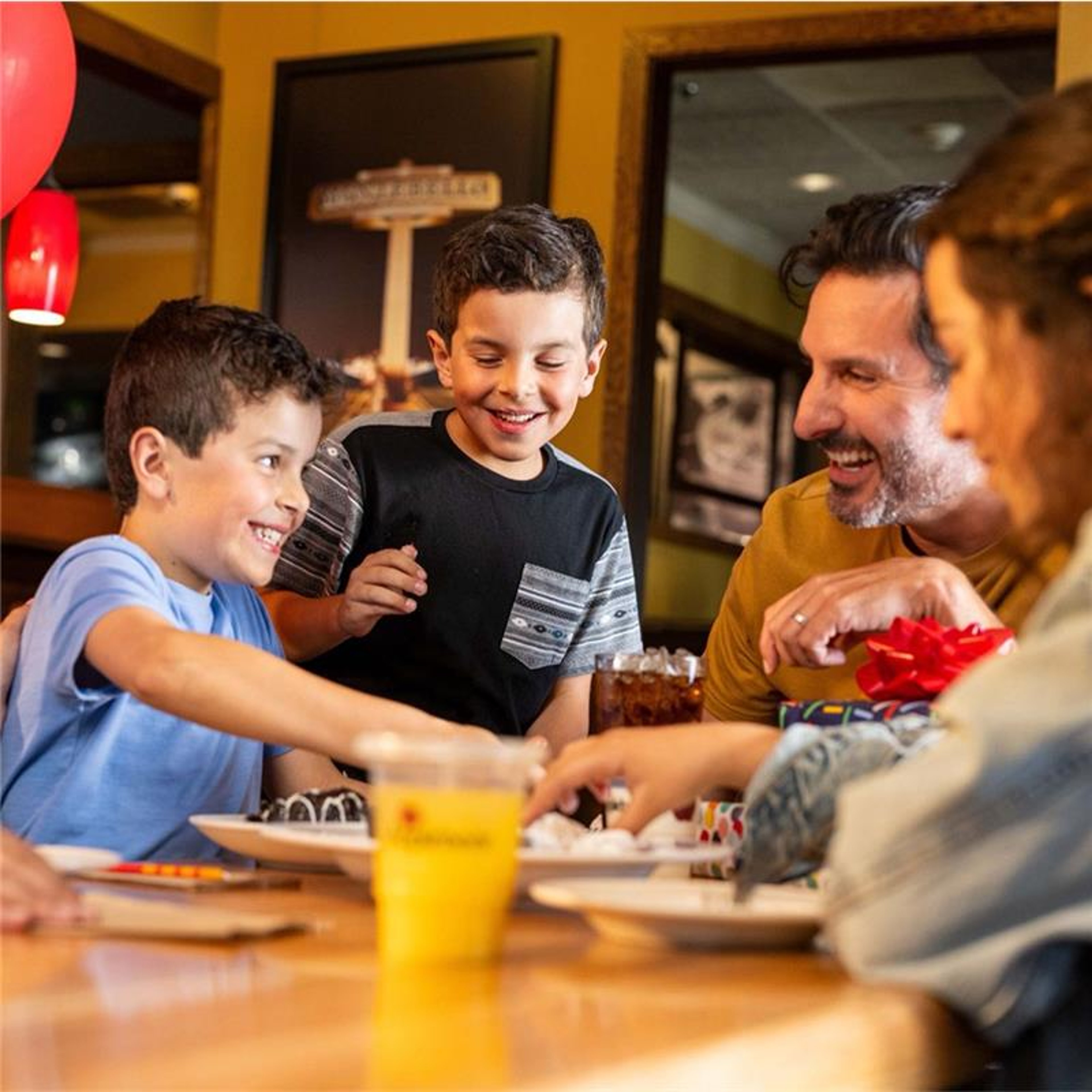 Happy family sitting at kitchen table enjoying a meal