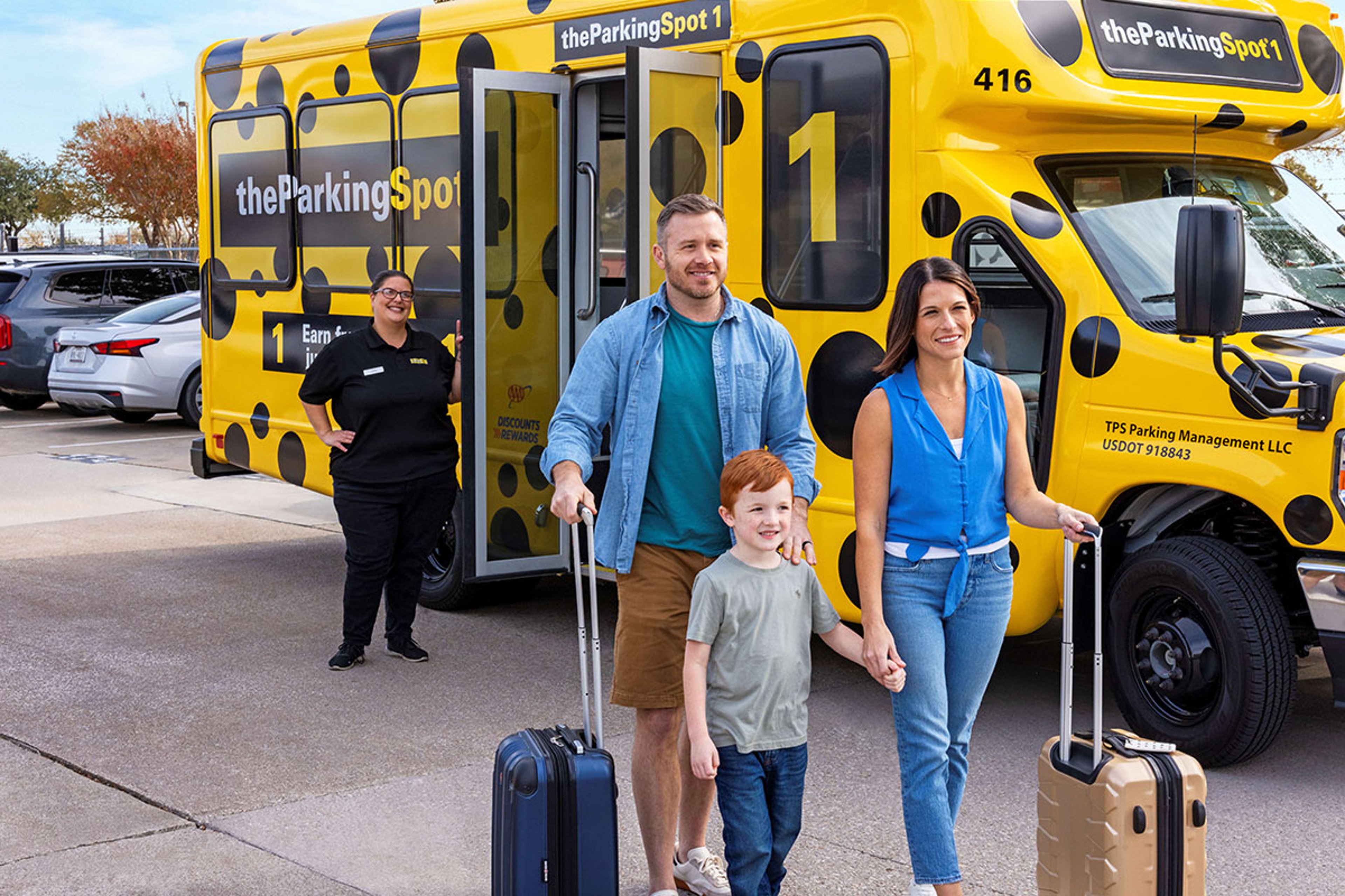 A family of three with suitcases walks away from a yellow polka-dotted shuttle bus labeled "theParkingSpot 1," with a bus attendant in the background.