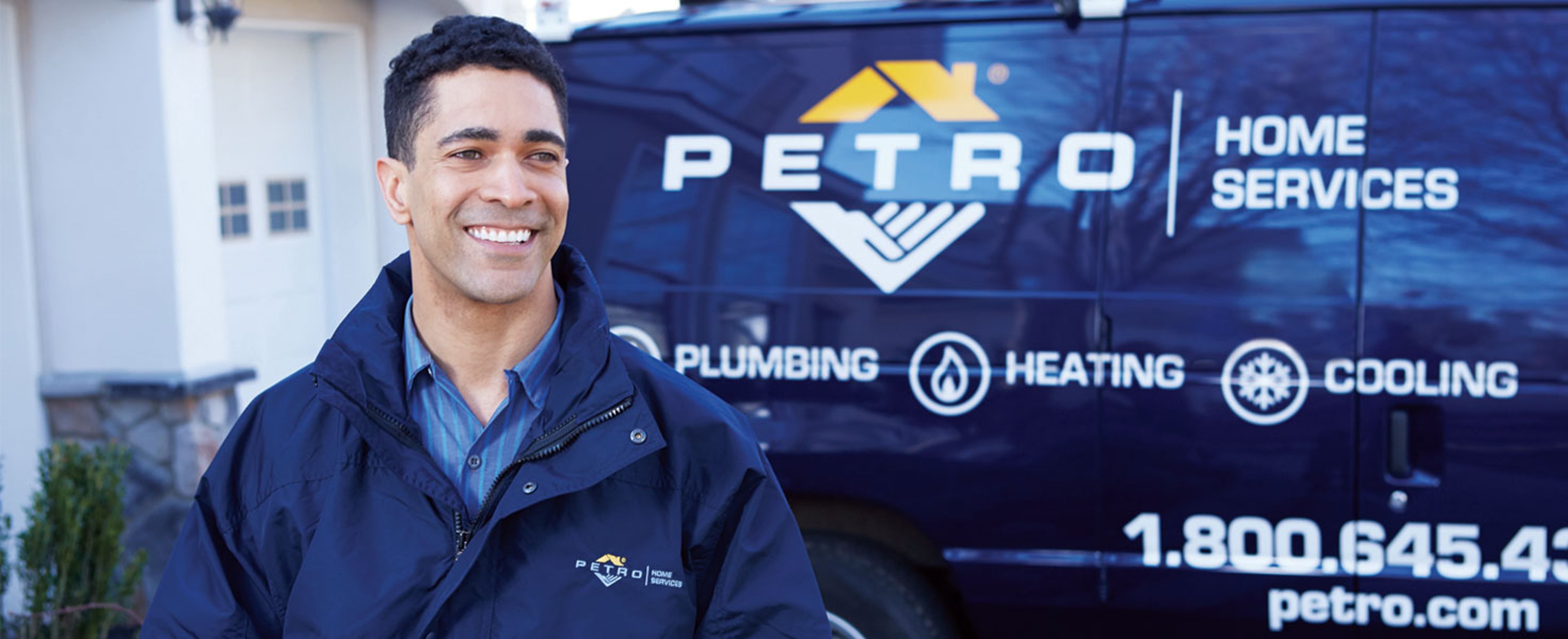 Petro Home Services Technician standing in front of service van